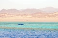 A small boat against the background of mountains and the sea in Ras Mohammed National Park, Egypt Royalty Free Stock Photo