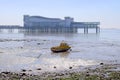 Small boat aground on beach at low tide