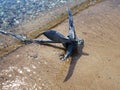 Small boat anchor at the beach sea shore