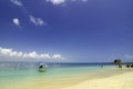 Small boat anchored with cloudy blue sky background and clear blue sea water. Royalty Free Stock Photo