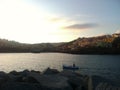 Small boat in a bay in front of a small italiant town Royalty Free Stock Photo