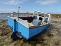 Small boat on beach at low tide