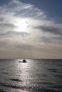Small boat captured in the sunlight off the coast of Thorpe Bay, Essex, England, United Kingdom Royalty Free Stock Photo