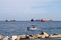 A small boat comes in to shore along the coast of Limassol, Cyprus