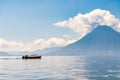 Small boat cruises past San Pedro Volcano, Lake Atitlan, Guatemala Royalty Free Stock Photo