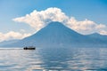 Small boat cruises past San Pedro Volcano, Lake Atitlan, Guatemala Royalty Free Stock Photo