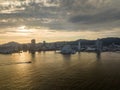 Small boat cruises toward Kobe Port and waterfront buildings at sunset