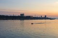 Small boat cruising Danube river at sunset Royalty Free Stock Photo