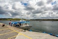 Small boat docked in the harbor and boats in the middle of the bay on Inishbofin Island