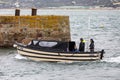 Small boat ferrying passengers across the sea from Marazion to St Michael`s Mount in Marazion, Cornwall, UK