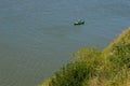 Small boat and a fisherman in the river