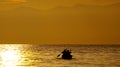 Small boat with the fishermen sailing into the sunset on the Kazinga Channel. Africa. Uganda.