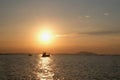 small boat floating on the sea at sunset Royalty Free Stock Photo