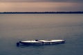 A small boat in a large body of water Royalty Free Stock Photo