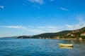 A small boat is moored near the shore beside the road around the Bay of Kotor at Durici in Montenegro Royalty Free Stock Photo