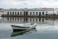 Small boat moored in the river crossing the city Royalty Free Stock Photo