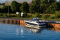 A small boat is moored to a jetty on a canal in Germany Royalty Free Stock Photo