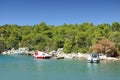 Small boat moored to rocky coast of the sea bay Royalty Free Stock Photo