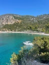 Small boat is moored in a tranquil bay, situated close to the green shoreline. Skopelos, Greece Royalty Free Stock Photo