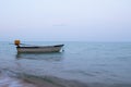 A small boat in the ocean with fishing boats in the distance off the coast of Cambodia Royalty Free Stock Photo