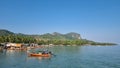 A small boat peacefully floats atop the calm waters of a serene lake, reflecting the clear blue sky above Royalty Free Stock Photo