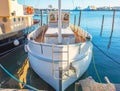 Small boat at the pier in the city, direct view