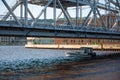 Small boat sailing under the Duluth Aerial Lift Bridge during the daytime