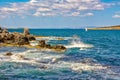 Small boat in the sea near rocky shore Royalty Free Stock Photo