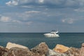 A small boat yacht in the sea near the shore. Beautiful clody sky on background. Royalty Free Stock Photo