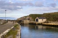 The small boathouse and slipway at Ballintoy harbor on the North Antrim Coast of Northern Ireland with its stone built boathouse o