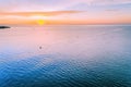 Small boats on calm ocean waters at sunset. Royalty Free Stock Photo