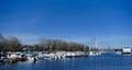 Small boats docked at the Sava River Yacht Harbor, and modern land bridge which connects Ada Ciganlija Island. Belgrade Royalty Free Stock Photo