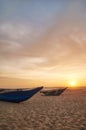 Small boats on an empty beach at sunset, Sri Lanka Royalty Free Stock Photo