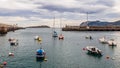 Small boats at the entrance of the fishing port of Bermeo on the coast of Vizcaya on a cloudy day