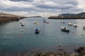 Small boats at the entrance of the fishing port of Bermeo on the coast of Vizcaya on a cloudy day