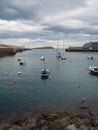 Small boats at the entrance of the fishing port of Bermeo on the coast of Vizcaya on a cloudy day