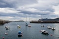 Small boats at the entrance of the fishing port of Bermeo on the coast of Vizcaya on a cloudy day