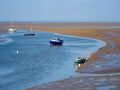 Small boats in the harbour at low tide Meols beach Wirral UK Royalty Free Stock Photo