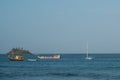 Small boats and island ocean horizon Royalty Free Stock Photo