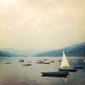 Small boats on the lake - vintage effect. Colorful retro photo. Royalty Free Stock Photo