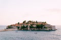 Small boats are moored near the isthmus of the island of Sveti Stefan. Montenegro