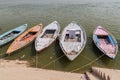 Small boats near Ghats riverfront steps leading to the banks of the River Ganges in Varanasi, Ind Royalty Free Stock Photo