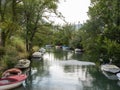 Small boats parking on river with green trees