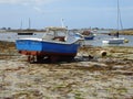 Small boats in harbour at low tide