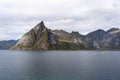the rocky shore is full of small boats sailing near the rocks, Hamnoy, Lofoten, Norway Royalty Free Stock Photo