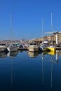 Small boats and sails docking mooring at Marseille old town harbor port on a blue sky day with water reflection, Southern France Royalty Free Stock Photo