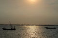 Small boats in the sea with light sunset sky Royalty Free Stock Photo