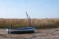 Small boats stranded at low tide on the coast of Norfolk, UK