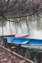 Small boats tied to a wooden dock day shot on lake Royalty Free Stock Photo