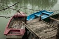 Small boats tied to a wooden dock day shot on lake Royalty Free Stock Photo